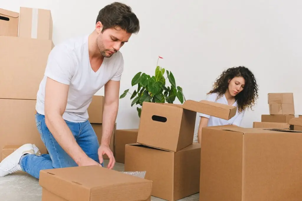 Man and Woman Packing the Boxes