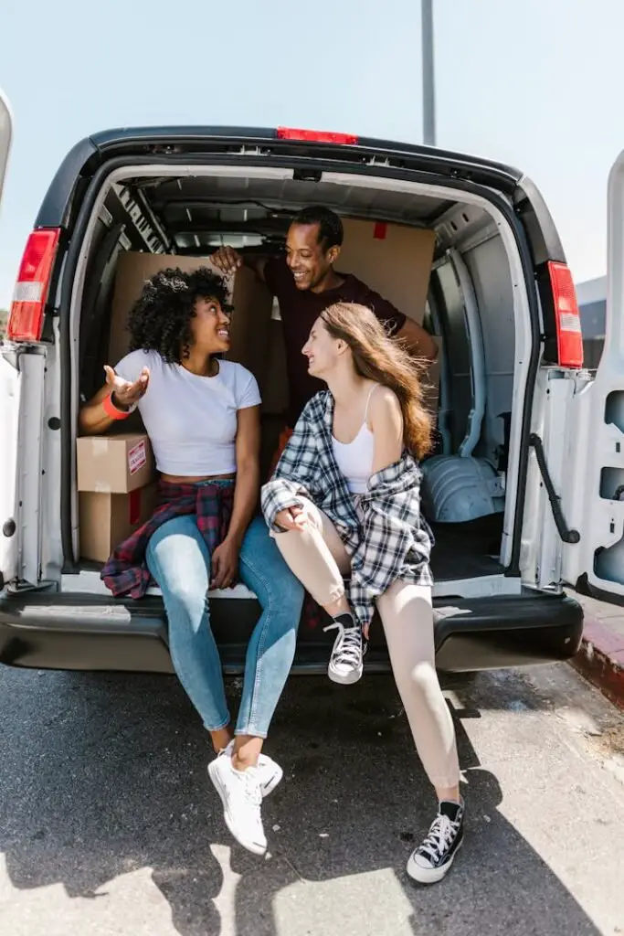 Man and Woman Sitting on White Van